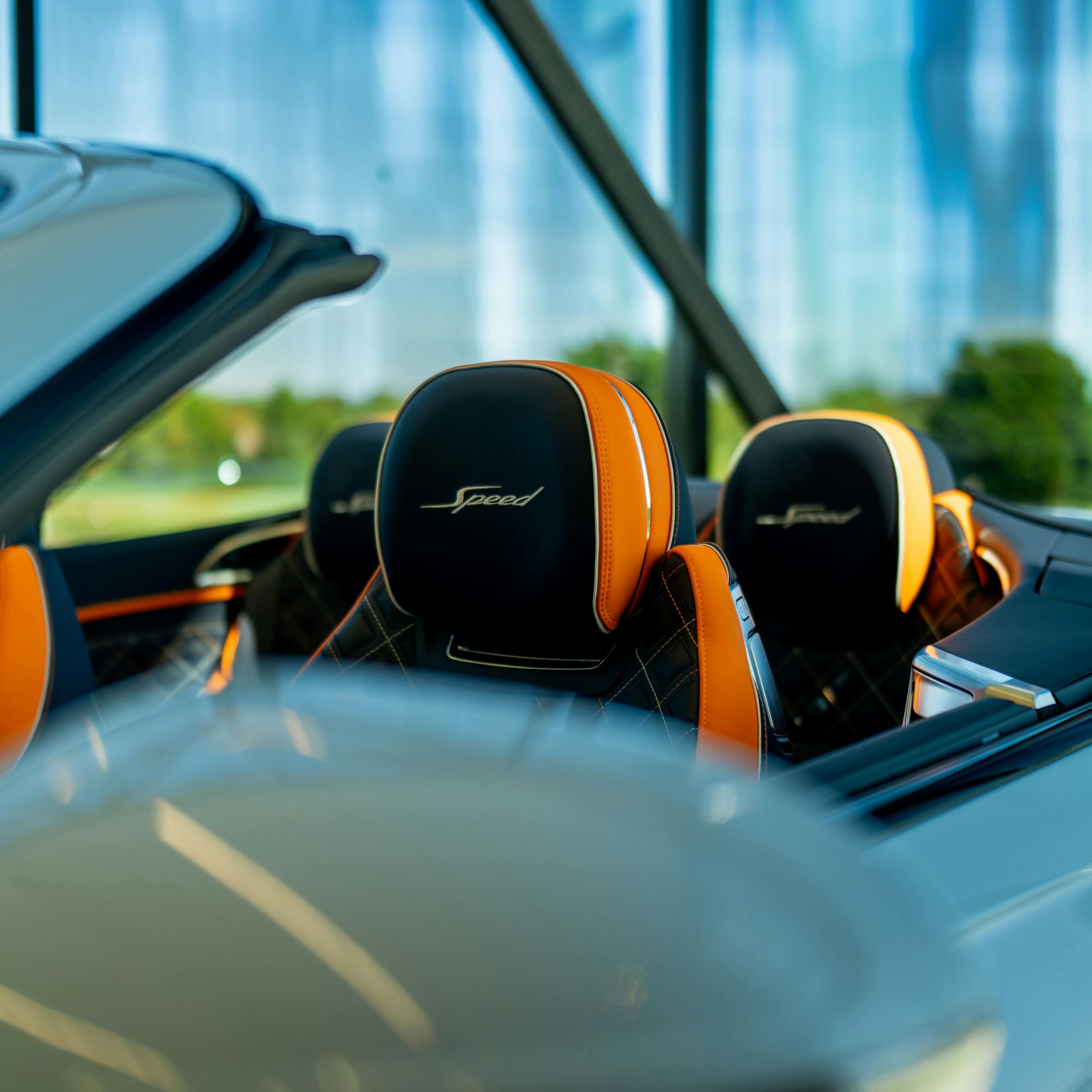 High-end convertible car interior featuring orange accents and luxury leather seats perfect for a modern lifestyle.